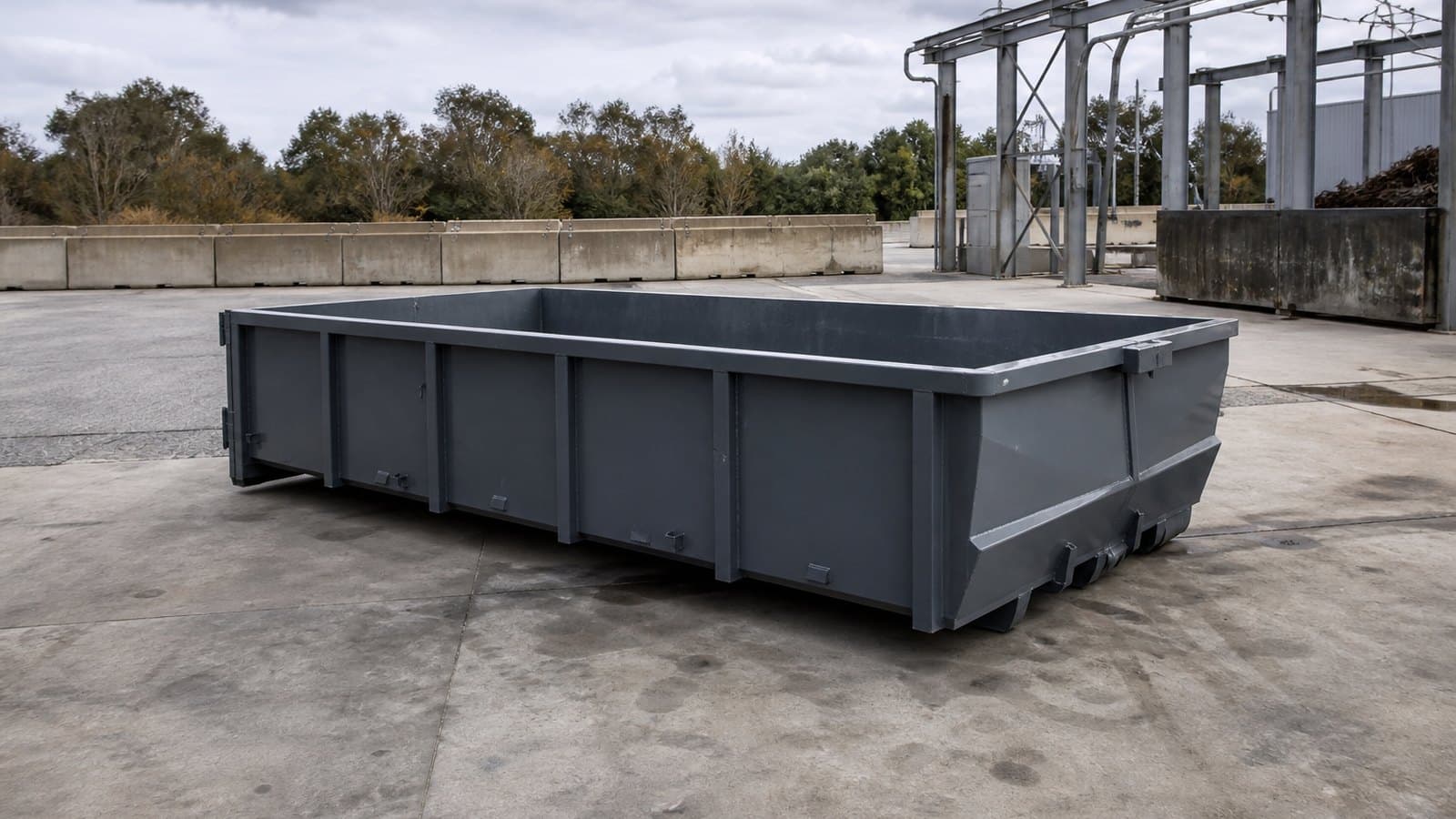 A roll-off bin positioned on a commercial hardstand