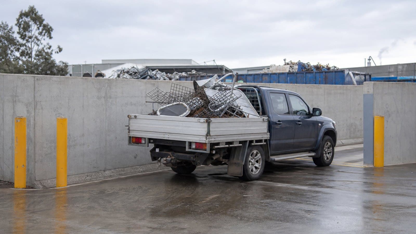 A ute being unloaded at a scrap metal drop-off bay