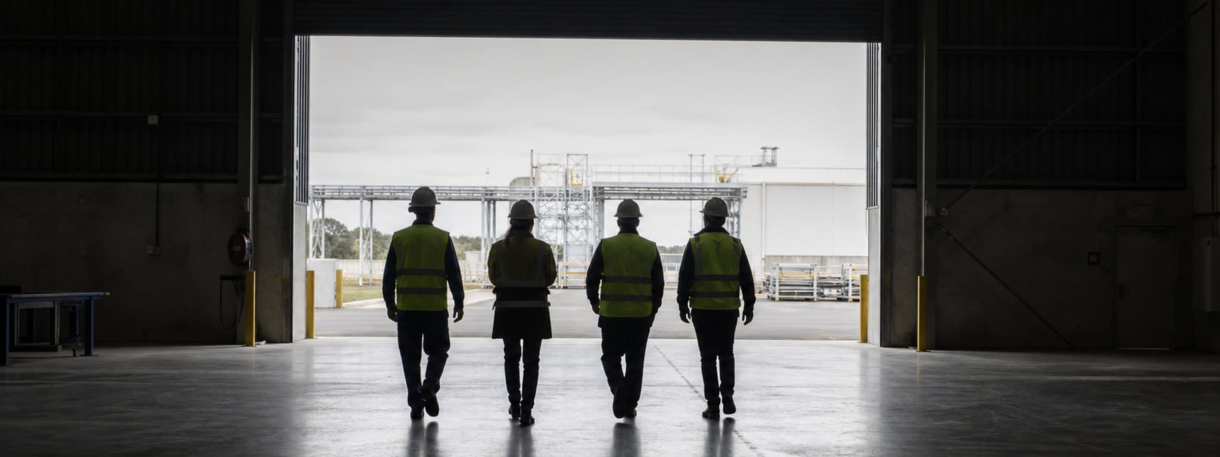 Recycling facility team in high-visibility workwear during a site briefing